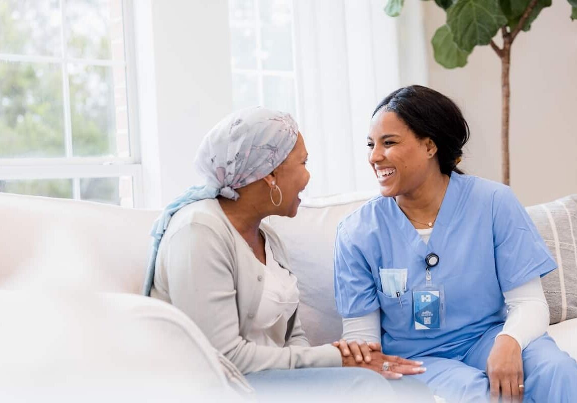 The nurse enjoys conversation with her patient.